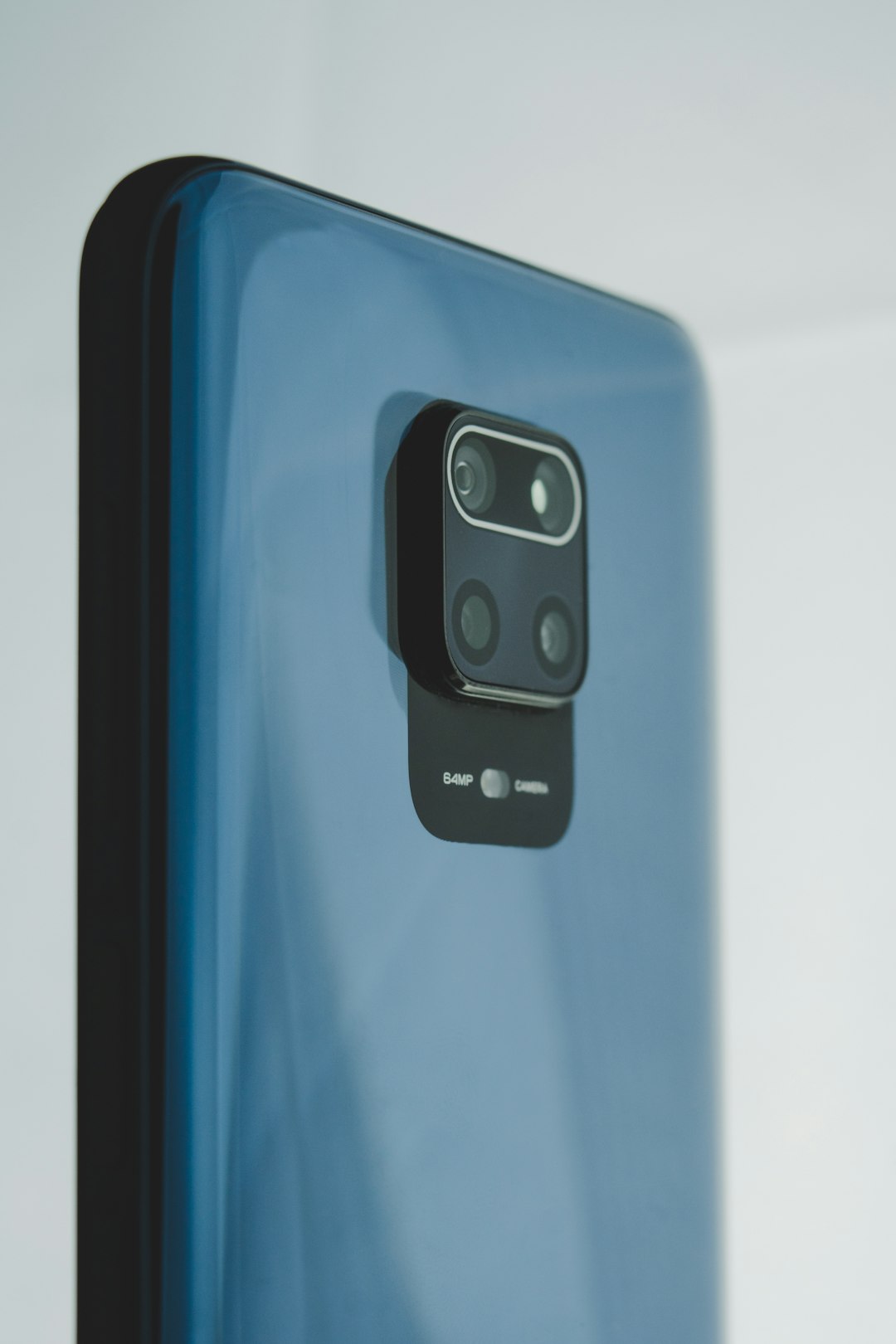 black-and-blue-smartphone-on-white-table-4pbz2tz3xsu